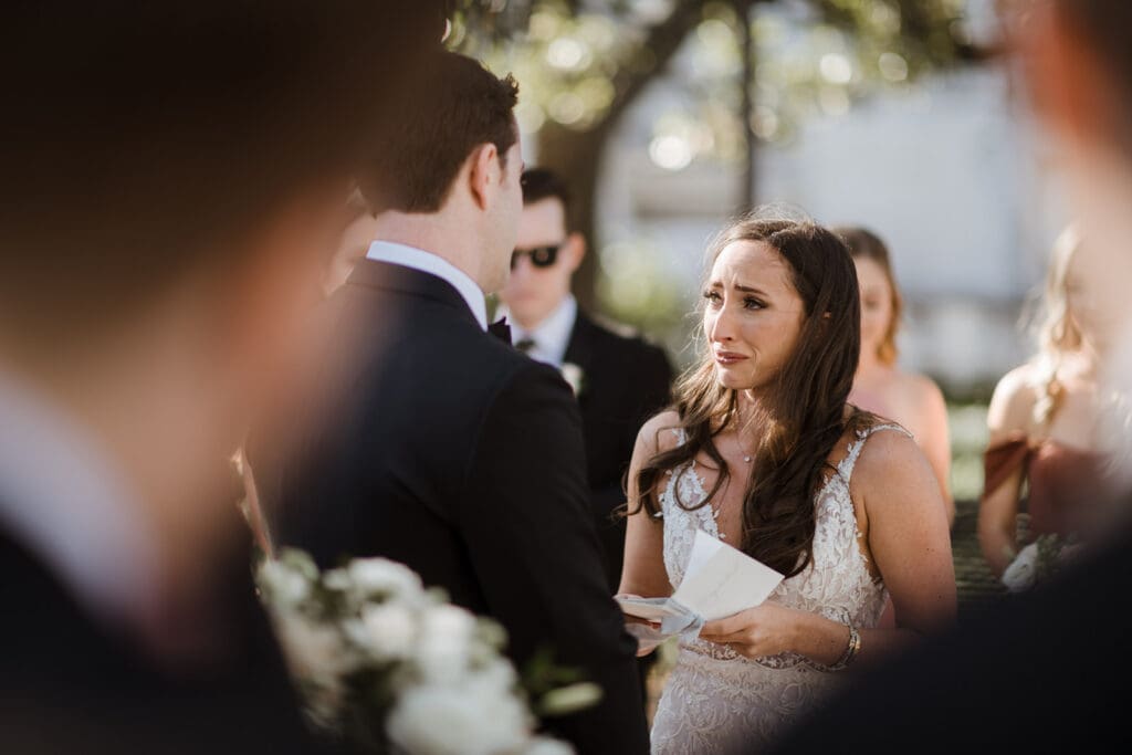 Couple holding letters while exchanging vows.

