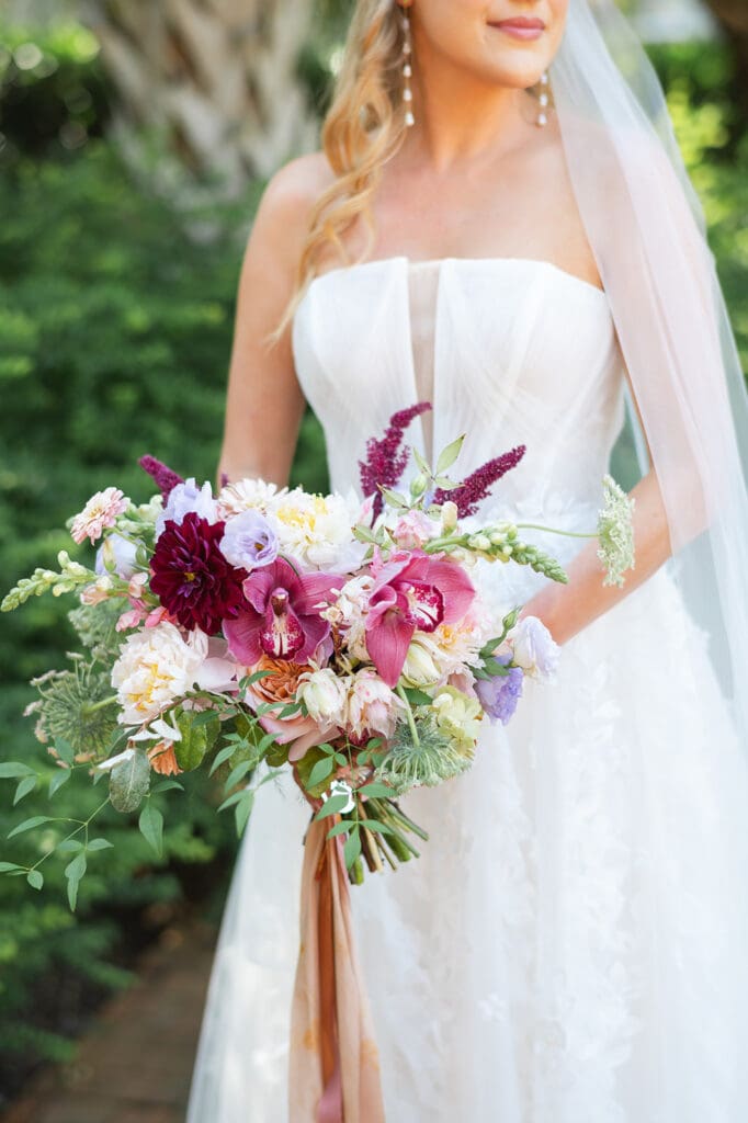 Luxury wedding videographer New Orleans capturing bridal portraits with bouquet